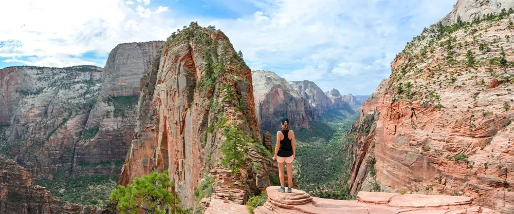 Woman standing on ledge in Zion National Park
